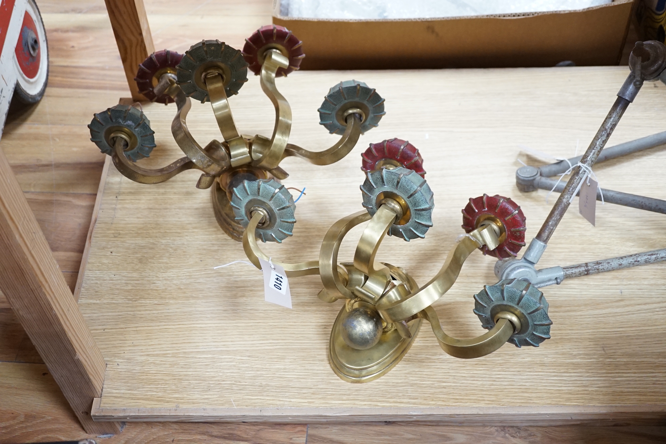 A pair of brass five branch wall lights